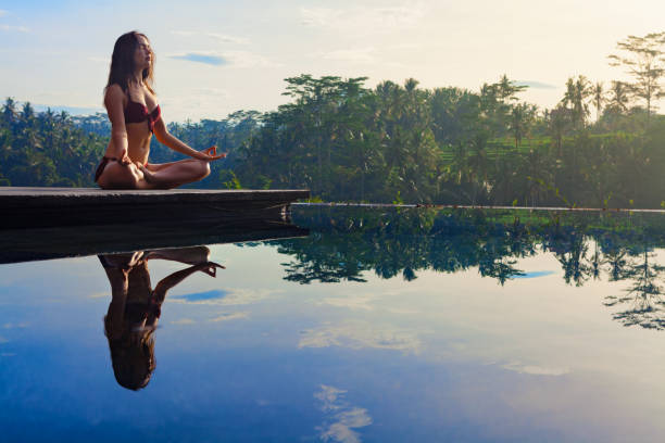 istock Good morning with yoga meditating on sunrise background 1237909929