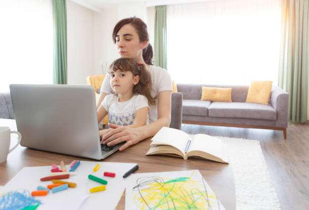 istock Young mother working and spending time with her daughter 1237926827