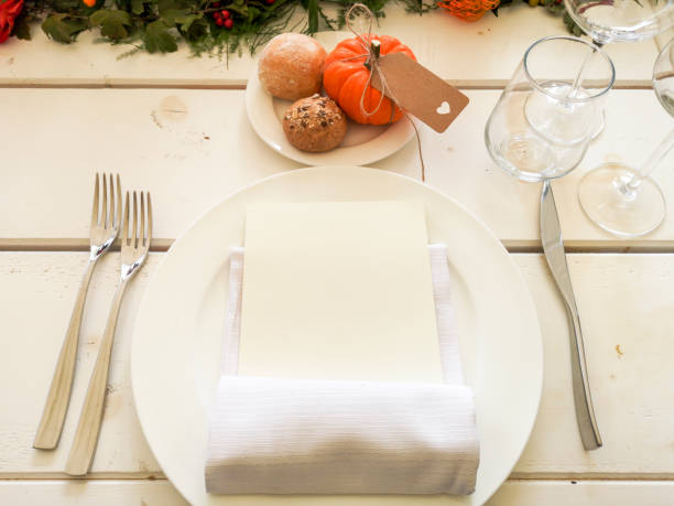 istock White striped wooden table, with plate and cutlery. Pumpkin with bread. 1237932071