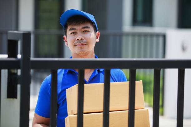 istock deliveryman holding cardboard box at customer home 1237936269