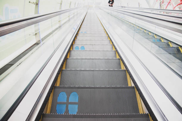 istock Footprints printed on the escalator for social distancing 1237944767