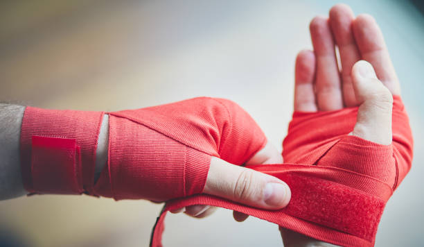 istock Closeup hand of boxer with red bandages 1237945292