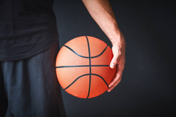 istock Basketball player with ball on black background 1237945305