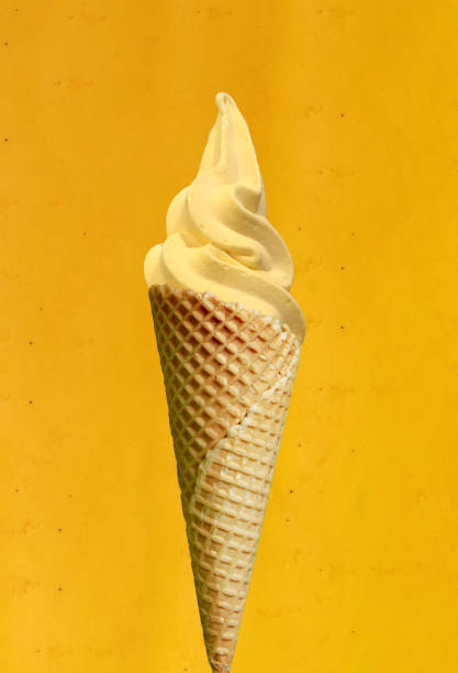 istock Banana soft ice cream in a waffle on a banana colored background 1237954358