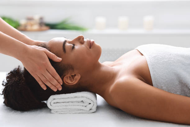 istock Young black woman getting head massage from massage therapist 1237956021