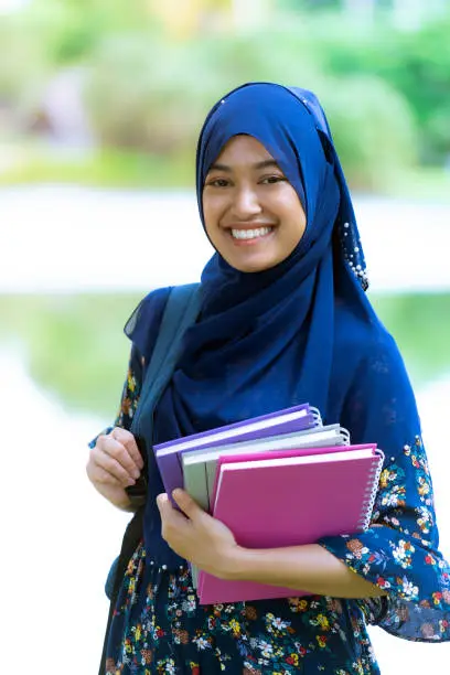 Photo of muslim girl student with books portrait