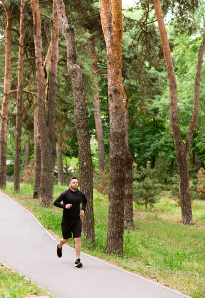 istock Male runner jogging on road, exercising outdoor 1237983653