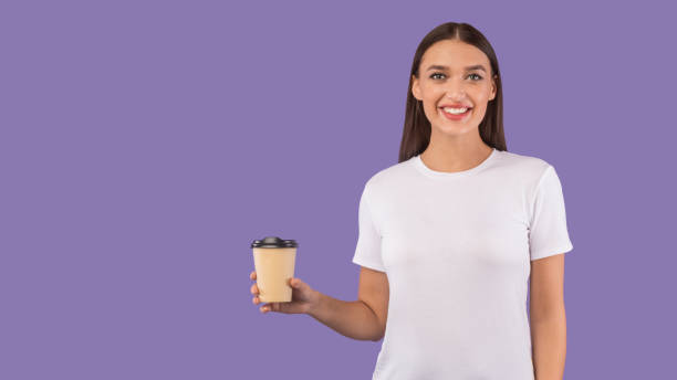 istock Portrait of cheerful youth holding hot beverage 1237983664