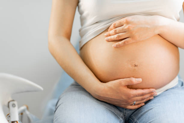 istock Pregnant woman hugging her belly 1237987334