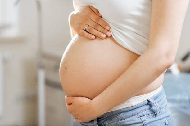 istock Pregnant woman's belly in a gynecological office 1237989490