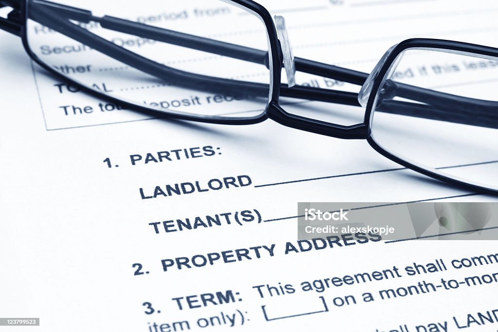 Residential lease agreement Close up of reading glasses on residential lease agreement Contract Stock Photo