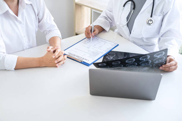istock Professor Doctor having conversation with patient and holding x-ray film while discussing explaining symptoms or counsel diagnosis health, healthcare and assistance concept 1238007743