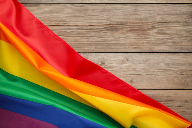 istock Rainbow LGBT flag on grey wooden background with copy space 1238008227