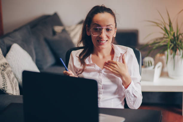 istock Young woman doing a video call on her laptop 1238008273