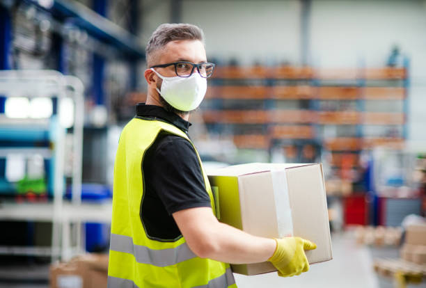 istock Man worker with protective mask working in industrial factory or warehouse. 1238008438