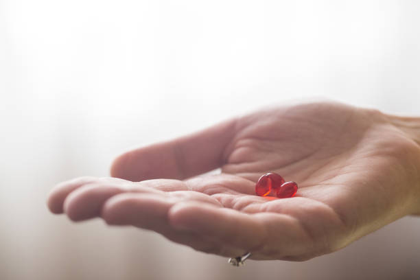 istock Close-ups of supplements in women’s hands 1238008645