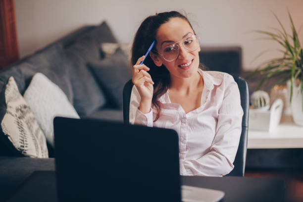 istock Young woman doing a video call on her laptop 1238008652