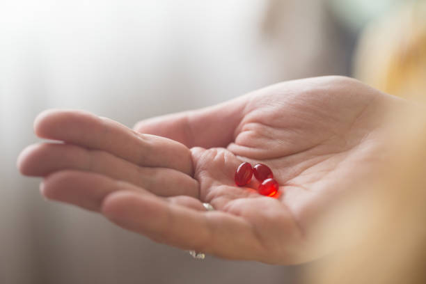 istock Close-ups of supplements in women’s hands 1238008656