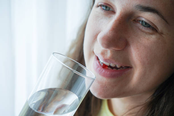 istock Woman drinks supplements with water. 1238008666