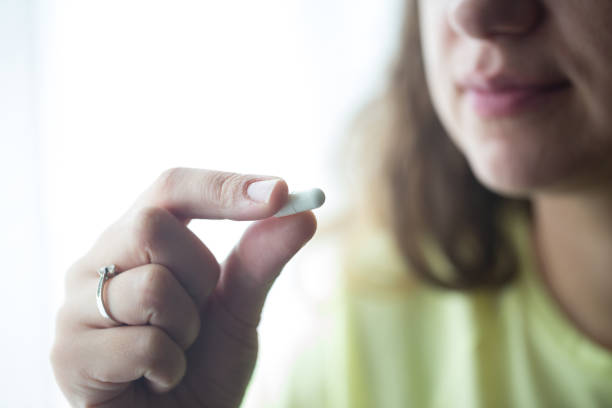 istock Woman putting supplements in mouths. 1238008738