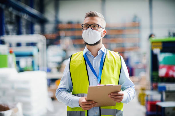 istock Technician or engineer with protective mask working in industrial factory, walking. 1238008753