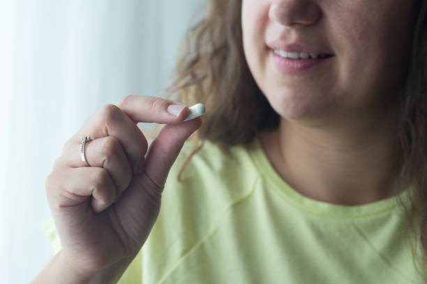 istock Woman putting supplements in mouths. 1238008772