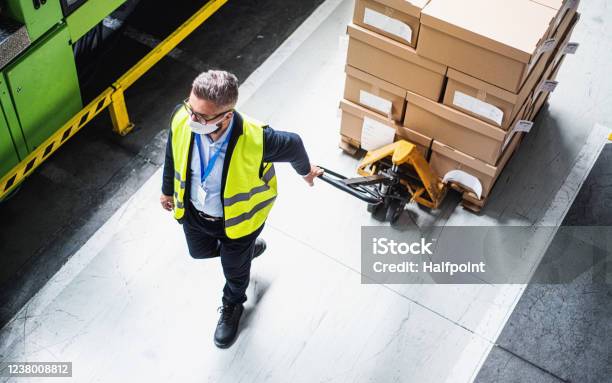 Top View Of Man Worker With Protective Mask Working In Industrial Factory Or Warehouse Stock Photo - Download Image Now