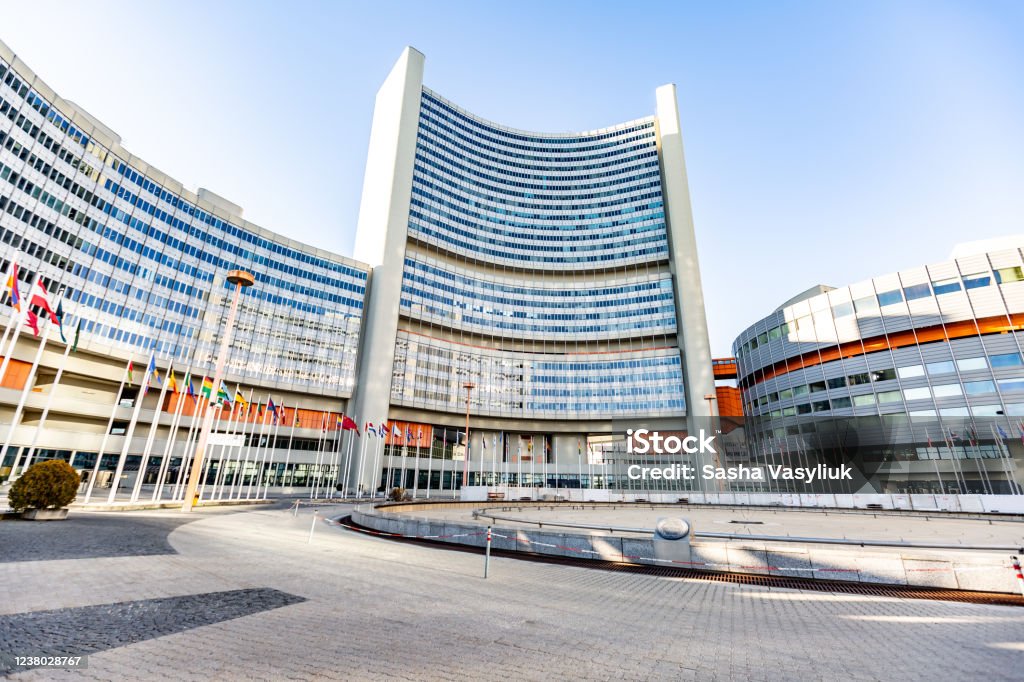 UN building in Vienna, Austria with flags on a sunny day against the sky. Horizontal orientation UN building in Vienna, Austria with flags on a sunny day against the sky. Horizontal orientation. High quality photo. Vienna - Austria Stock Photo