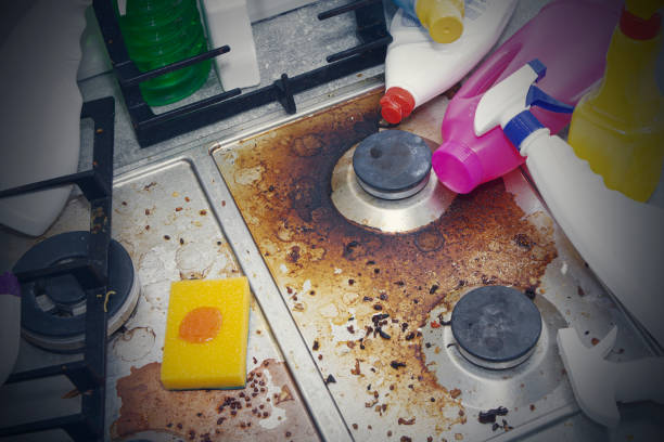 istock dirty kitchen stove, empty and full bottles of detergents around. 1238030412