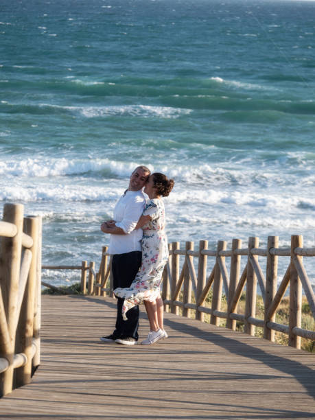 istock Two young lovers enjoying a walk together to the sea 1238067785