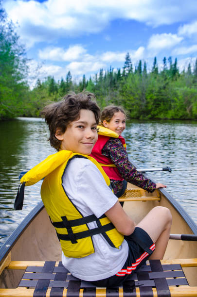 istock Two kids in front of canoe 1238080320