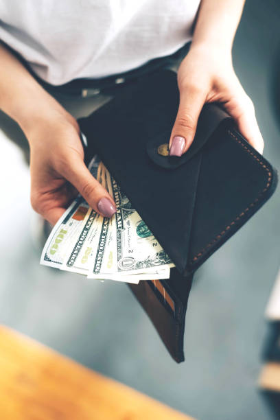 istock Wallet with dollar bills in female hands. 1238093867