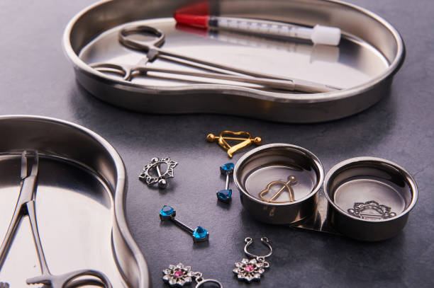 istock Piercing tools lie in a stainless steel disinfection container on a black background 1238105946