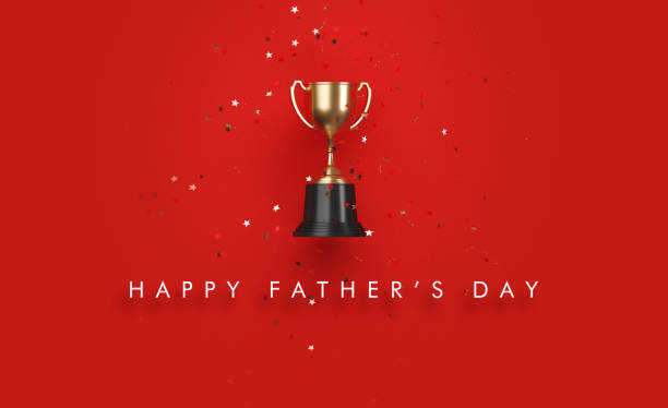 Star shaped confetti falling over gold cup sitting over red background. Happy Father's Day written below the cup. Horizontal composition with copy space. Directly above.