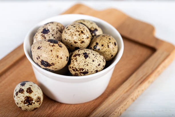 istock Quail eggs in white bowl on wooden background 1238149005