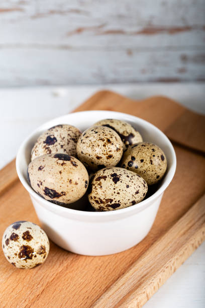 istock Quail eggs in white bowl on wooden background 1238150549