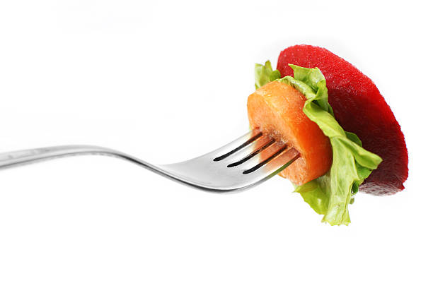 A plate of leafy greens and sliced tomatoes arranged with care, surrounded by subtle kitchen elements. The image evokes freshness, calm, and healthy living.