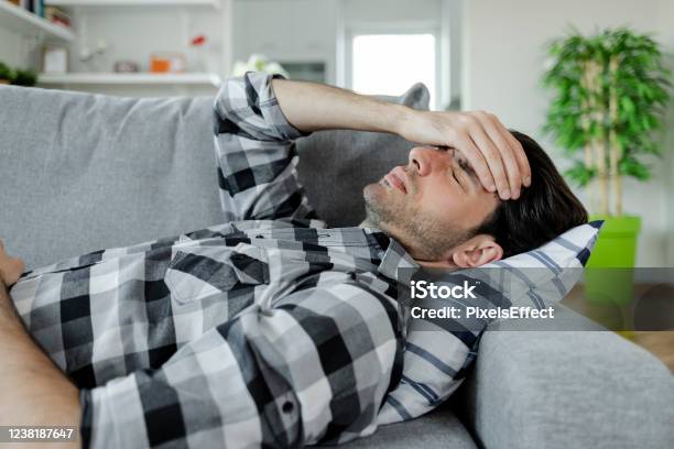 Headaches Always Hit You At The Worst Times Stock Photo - Download Image Now - Lying Down, Pain, Sofa