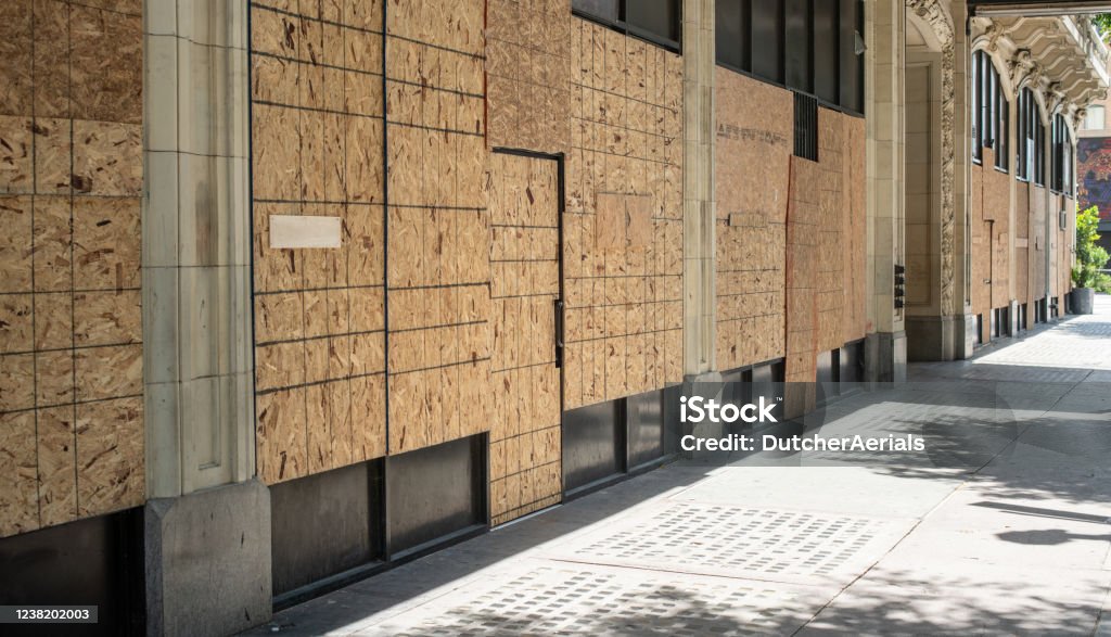 Boarded up windows during George Floyd protest in downtown Los Angeles Businesses boarded up in downtown Los Angeles in preparation of riots and protestors. Riot Stock Photo