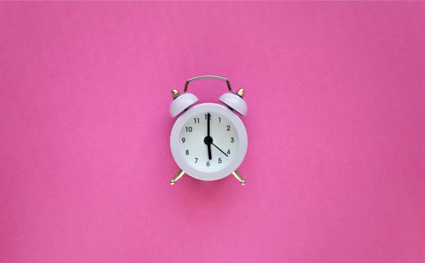 istock Vintage light alarm clock on pink background with copy space. Minimal thing. Minimal think 1238251909