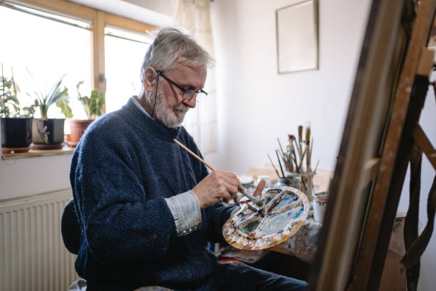 istock Senior man painting 1238256861