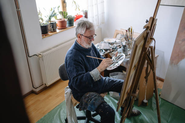 istock Senior artist painting a canvas 1238256958
