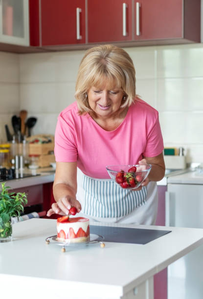 istock Senior woman making a cake 1238267639