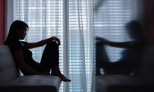 istock sad woman seating alone 1238290012