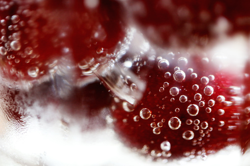 Fresh cherries in soda with bubbles