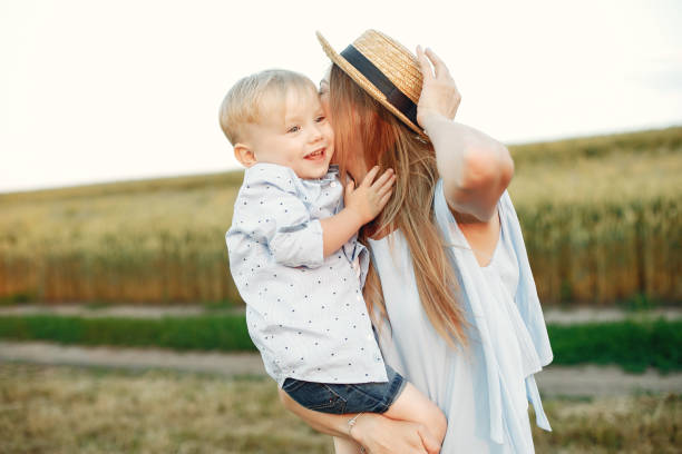 istock Mother with son playing in a summer field 1238297346