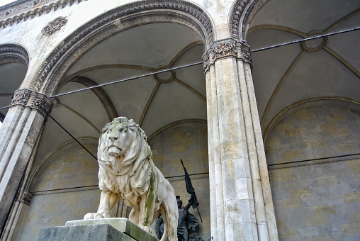 Entrance of the old Cuban office building with statue of the Lion on the steps