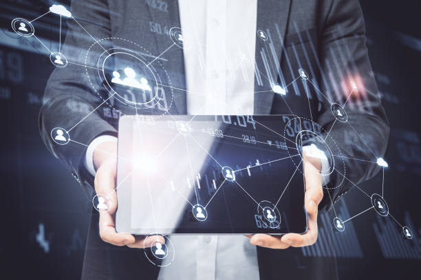 istock Businessman holding digital tablet with global social network 1238316308