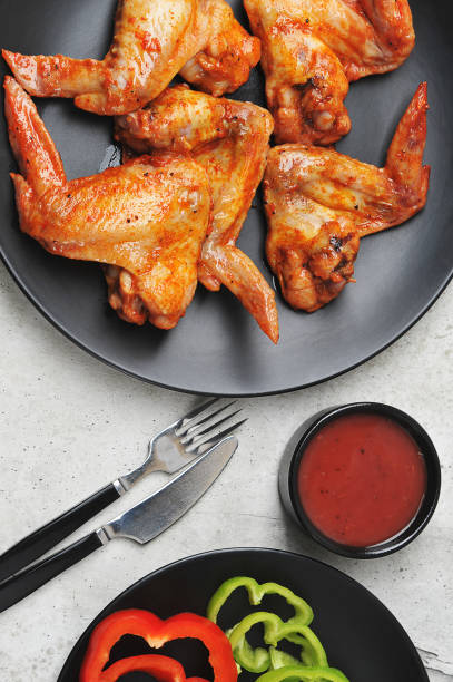 istock fried marinated chicken wings on a black plate 1238328847