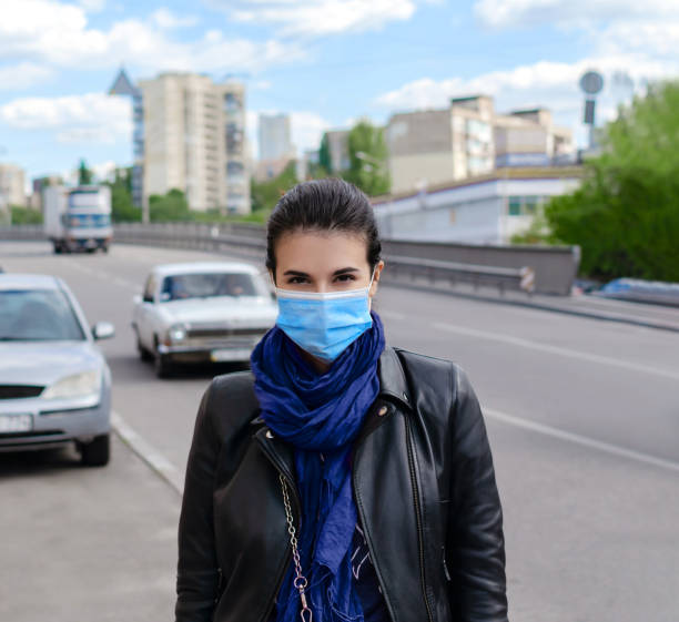istock medical mask on a female face, protective equipment 1238340318